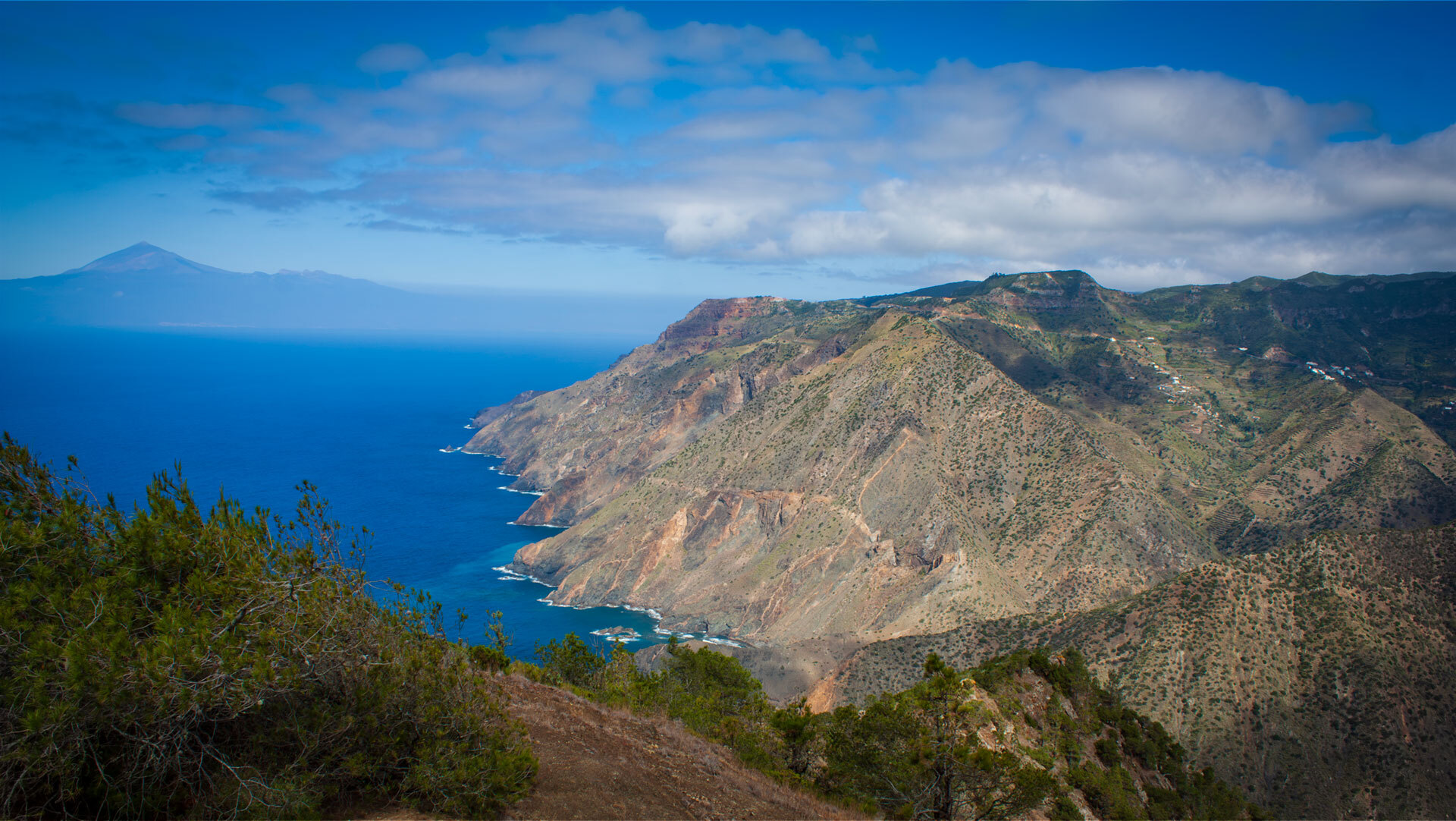 Panoramablick von der Cumbre de Chijere über die Küste La Gomeras bis Teneriffa.